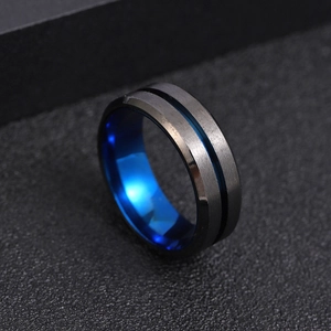 Detail of two-tone matte brushed black surface and polished blue inner spinning ring