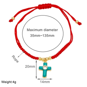 Detail showing the adjustable red braided string bracelet with a turquoise cross pendant
