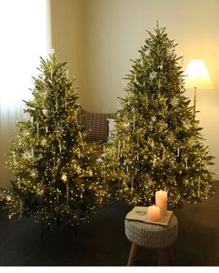 Cozy festive setting featuring acrylic crystal snowflakes and warm LED lights on Christmas trees