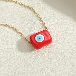 Golden chain necklace with rectangular red evil eye pendant for a trendy stylish look