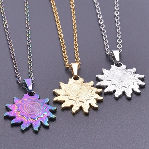 Detailed macro view of 18k gold and silver sun-shaped pendants with spiral ray patterns