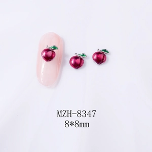 Detailed view of 8x8mm peach metal nail art charms with pink finish and green leaf