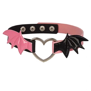 Detail of pink and black leather choker featuring a silver heart ring and bat wings