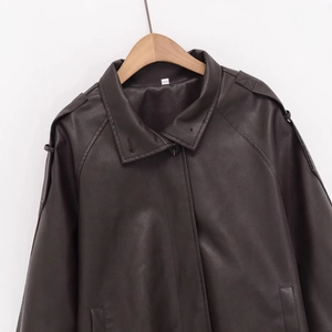Relaxed fit dark faux leather jacket featuring drop shoulder and classic button closure