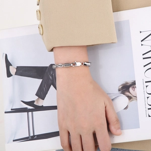 Silver twisted rope bracelet with lobster clasp on wrist for a stylish fashion look