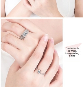 Detail of silver couple rings with geometric cutouts and square cut diamond on model hand