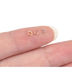 Three-color stainless steel jump rings for DIY jewelry making shown on fingertips