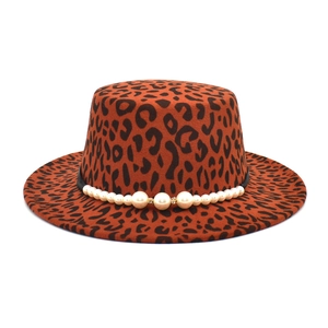 Detail of leopard print wool fedora featuring white pearl band and golden accents