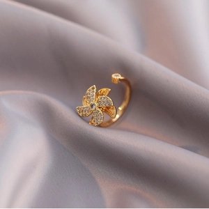 Rotating gold windmill ring with sparkling cubic zirconia and adjustable band on silk