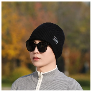 Detailed close-up of a black knit beanie featuring a white IFARDI branded textile label