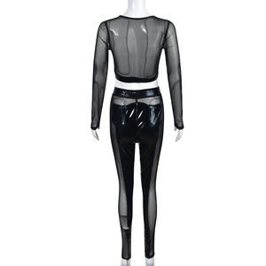 Rear view of black two-piece set featuring mesh patchwork and glossy long sleeve top with pants
