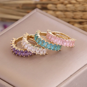 Detailed view of 18K gold rings featuring colorful square zircon stones in classic settings