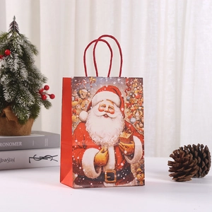 Christmas paper gift bag featuring vintage Santa Claus illustration with red handles