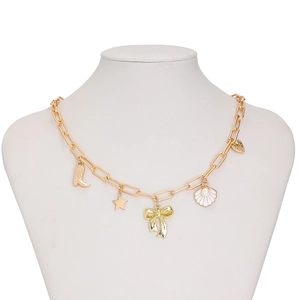 Detail of golden charm necklace featuring bow, shell with pearl, and star pendants