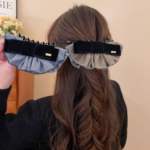 Détail de pinces à cheveux en velours avec bordure en dentelle et étiquette dorée