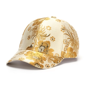 Detail of premium cotton baseball cap featuring intricate gold floral jacquard texture