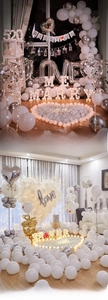 Close-up of romantic wedding decor with Marry Me light-up letters and rose petals