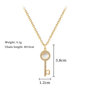 Detail shot of golden cat eye stone key necklace with dimension and weight markings