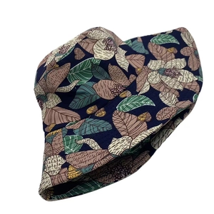 Detail of floral sun hat with retro dark blue flower and leaf print pattern
