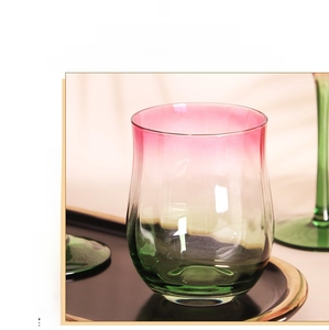Detail of hand-blown gradient wine glass with ribbed texture on a premium gold tray