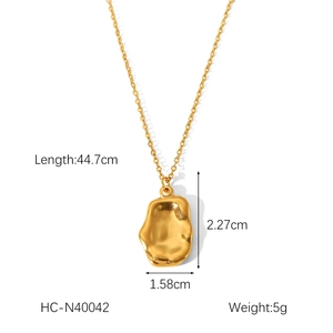 Detailed view of golden necklace with dimensions 44.7cm length and irregular pendant