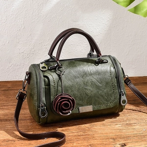 Vintage dark green Boston bag in textured leather with a rose charm and crossbody strap