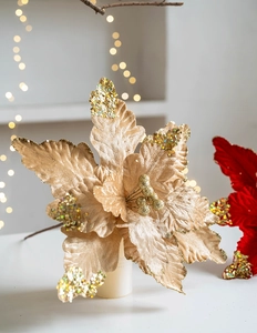 Close-up of velvet poinsettia flowers with glittering champagne gold and red petals