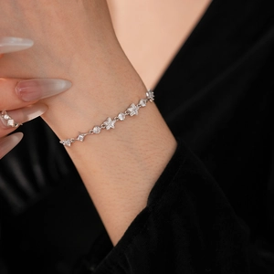 Detail shot of elegant silver bracelet with sparkling star and round zircon gemstones