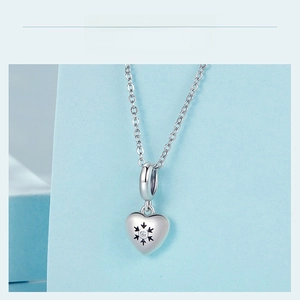 Close-up of 925 sterling silver heart pendant with snowflake pattern and sparkling crystal