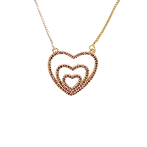 Golden necklace with triple-layered heart pendant and red zircon stones on white background