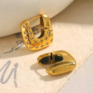 Macro shot of 18K gold plated square hoop earrings with sparkling star zircon inlays