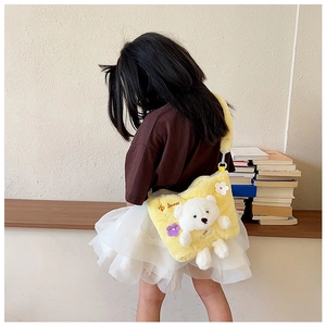 Detail of yellow plush kid shoulder bag featuring a 3D bear and embroidered Sweet text