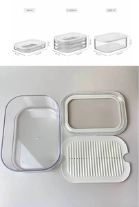 Detailed view of stackable food storage container with white lid and drainage rack