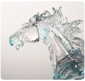 Close-up of translucent light blue resin horse head statue with crystal texture