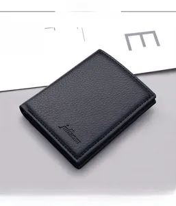 Detailed close-up of vertical men's wallet in black lychee grain leather with fine stitching