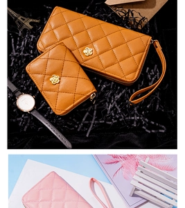 Detailed view of quilted faux leather wallets with camellia metal buckles and wrist straps