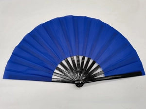 Detail view of a 10-inch deep blue fabric folding fan with black bamboo ribs and metal rivet