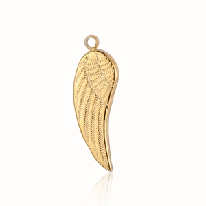 Detailed macro view of golden angel wing pendant with intricate feather texture