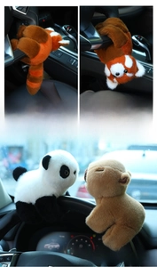 Detail of red panda plush slap bracelet wrapped around a car steering wheel
