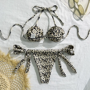 Detailed view of leopard print bikini with size S label and soft summer accessories