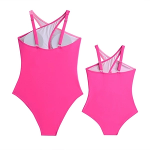 Pink mother and daughter matching one-piece swimsuits with cross straps and removable pads