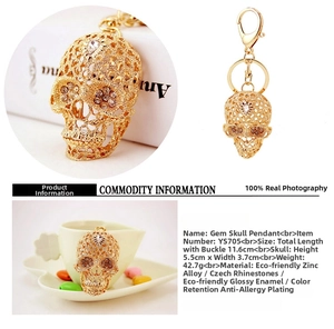 Detailed views of gold-plated crystal skull keychain with sparkling rhinestone eyes