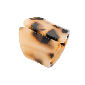 Macro shot of minimalist brown leopard print acrylic ring with smooth glossy finish