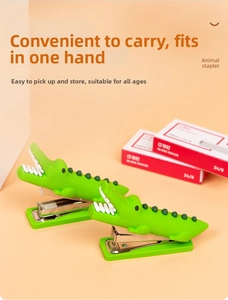 Detailed close-up of green crocodile-shaped mini staplers with textured skin finish