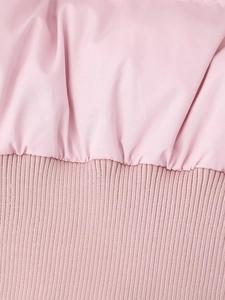 Detail of pink cotton jacket showing smooth fabric and ribbed knit stitching quality