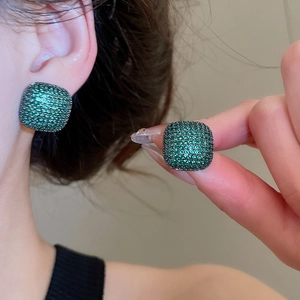 Close-up of square emerald cubic zirconia stud earrings with pavé set crystals