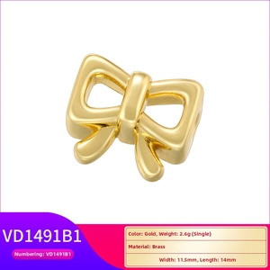 Detailed macro view of a vintage style golden brass bow charm for jewelry making