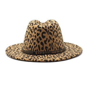 Close-up of leopard print fedora hat featuring a black leather band with metal rivets