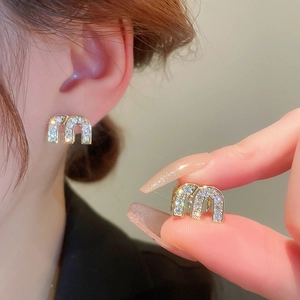 Elegant gold earrings with double-sided letter M design and sparkling white cubic zirconia