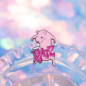 Pink cartoon mouse enamel pin with RATZ lettering on iridescent glass edge